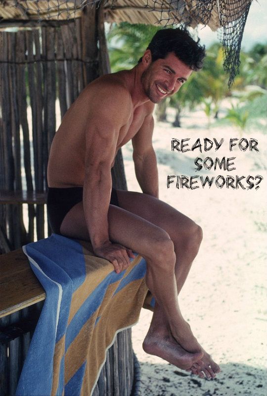 sexy-man-in-a-speedo-smiling-while-sitting-on-a-cabana